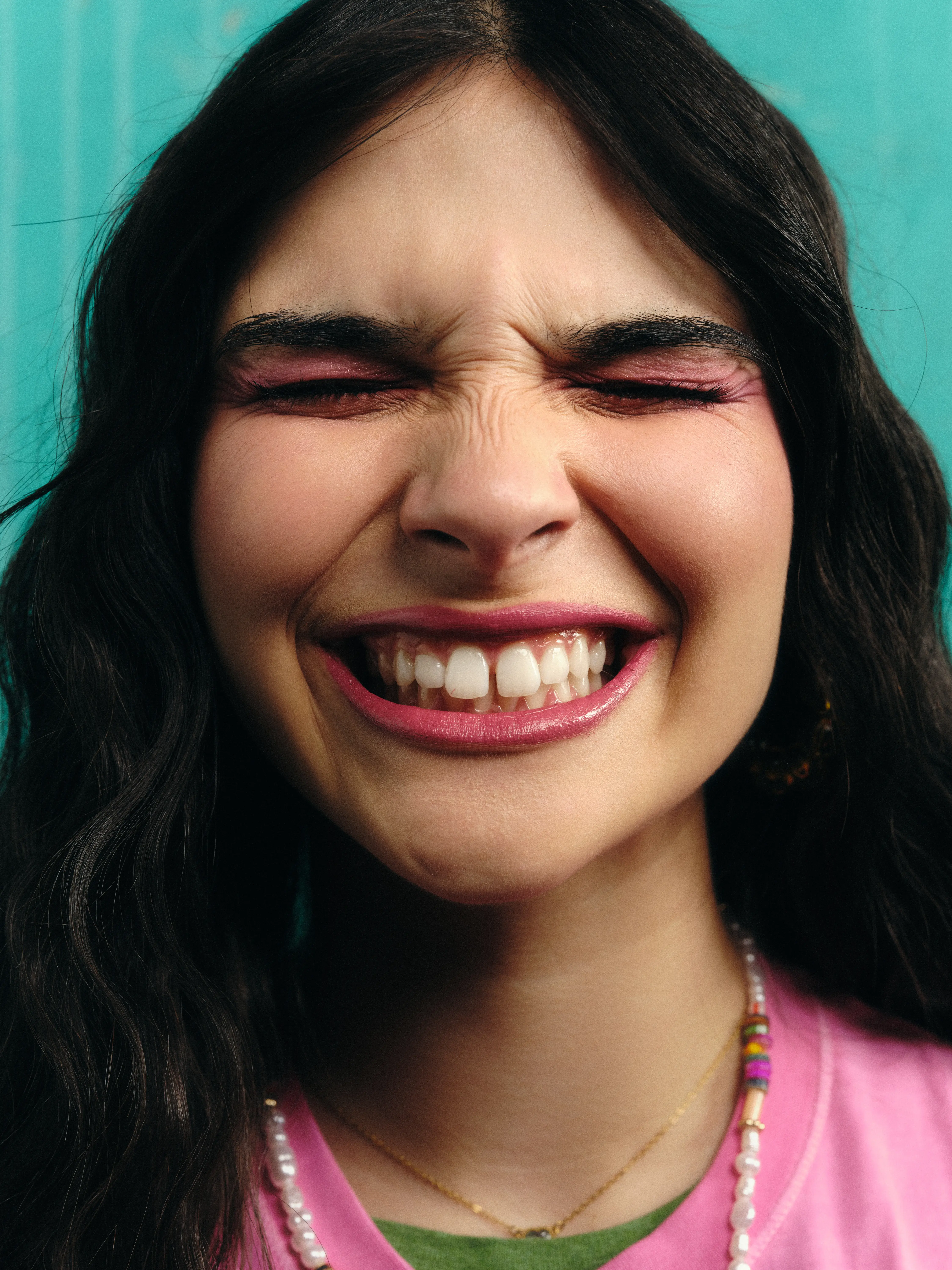 Mulher a sorrir com dentes alinhados após tratamento ortodôntico